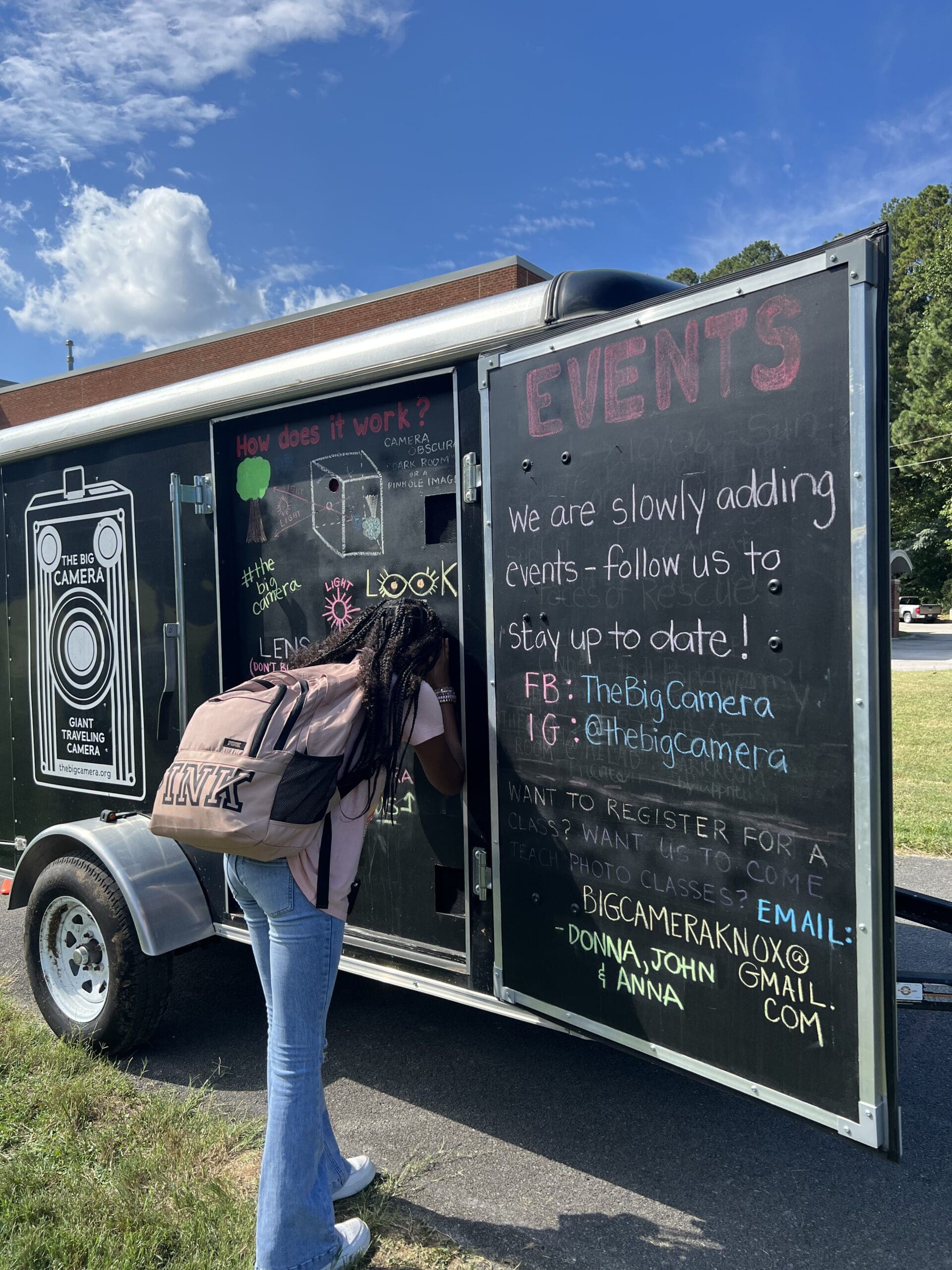 Public events. A person looking into a large camera obscura.